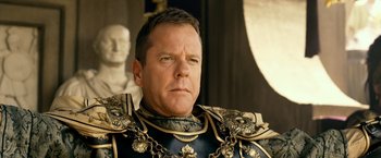 Movie still from “Pompeii” (2014), directed by Paul W.S. Anderson – A person wearing a suit of armor; Close Up shot, Low angle