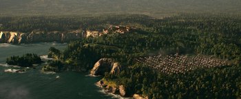 Movie still from “Pompeii” (2014), directed by Paul W.S. Anderson – An aerial view of a forest with a castle on top of it; Extreme Wide shot, High angle