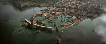 Movie still from “Pompeii” (2014), directed by Paul W.S. Anderson – An aerial view of an ancient city in the middle of the ocean; Extreme Wide shot, High angle