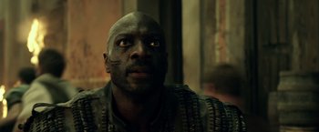 Movie still from “Pompeii” (2014), directed by Paul W.S. Anderson – A person wearing a mask; Close Up shot, Low angle