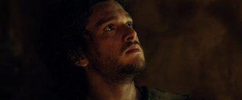 Movie still from “Pompeii” (2014), directed by Paul W.S. Anderson – A person with a beard looking up; Close Up shot, Low angle