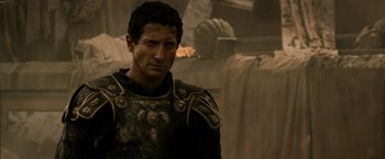 Movie still from “Pompeii” (2014), directed by Paul W.S. Anderson – A person wearing armor; Close Up shot, Over the shoulder angle