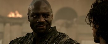 Movie still from “Pompeii” (2014), directed by Paul W.S. Anderson – A person wearing a black shirt; Close Up shot, Over the shoulder angle