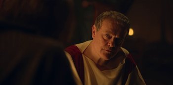 Movie still from “Barbarians” (2020), created by Arne Nolting – An older man wearing a roman outfit looking at the camera; Close Up shot, Over the shoulder angle