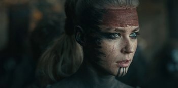 Movie still from “Barbarians” (2020), created by Arne Nolting – A person with makeup on her face; Close Up shot, Over the shoulder angle