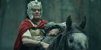 Movie still from “Barbarians” (2020), created by Arne Nolting – A man dressed as a roman soldier on a horse; Close Up shot, Low angle