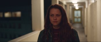 Movie still from “Berlin Syndrome” (2017), directed by Cate Shortland – A woman with long red hair is looking at the camera; Medium shot, Over the shoulder angle