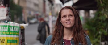 Movie still from “Berlin Syndrome” (2017), directed by Cate Shortland – A woman with long red hair standing on the sidewalk; Close Up shot, Low angle