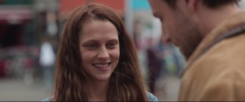 Movie still from “Berlin Syndrome” (2017), directed by Cate Shortland – A young woman smiles as she talks to a young man; Close Up shot, Over the shoulder angle