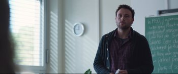 Movie still from “Berlin Syndrome” (2017), directed by Cate Shortland – A man standing in front of a wall holding a wii controller; Medium shot, Low angle