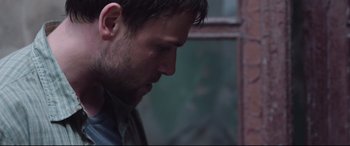 Movie still from “Berlin Syndrome” (2017), directed by Cate Shortland – A person looking down at his face; Close Up shot, Over the shoulder angle