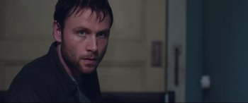 Movie still from “Berlin Syndrome” (2017), directed by Cate Shortland – A person wearing a suit and tie; Close Up shot, Over the shoulder angle