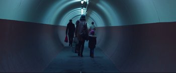 Movie still from “Berlin Syndrome” (2017), directed by Cate Shortland – A group of people walking down a tunnel; Wide shot, Low angle