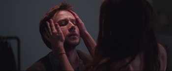 Movie still from “Berlin Syndrome” (2017), directed by Cate Shortland – A woman touching a man's face in front of a bathroom mirror; Close Up shot, Over the shoulder angle