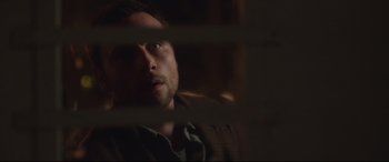 Movie still from “Berlin Syndrome” (2017), directed by Cate Shortland – A person looking through a window; Close Up shot, Over the shoulder angle