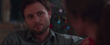 Movie still from “Berlin Syndrome” (2017), directed by Cate Shortland – A man's face in front of a christmas tree; Close Up shot, Over the shoulder angle