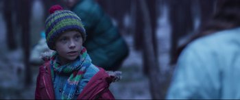 Movie still from “Berlin Syndrome” (2017), directed by Cate Shortland – A young boy wearing a colorful hat and jacket; Close Up shot, Over the shoulder angle