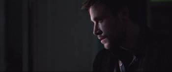 Movie still from “Berlin Syndrome” (2017), directed by Cate Shortland – A person with a beard looking to the side; Close Up shot, Over the shoulder angle