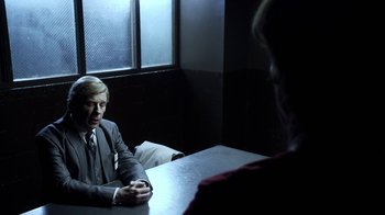 Movie still from “Better Call Saul” (2015), created by Vince Gilligan – A man sitting at a table in front of another man; Medium shot, Over the shoulder angle