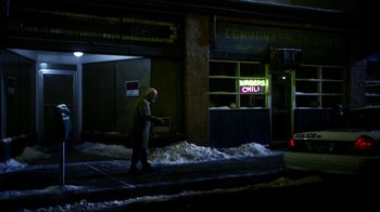 Movie still from “Better Call Saul” (2015), created by Vince Gilligan – A man walking down the sidewalk in front of a building; Wide shot, High angle