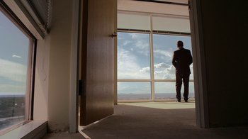 Movie still from “Better Call Saul” (2015), created by Vince Gilligan – A man standing in front of a large window; Wide shot, Low angle
