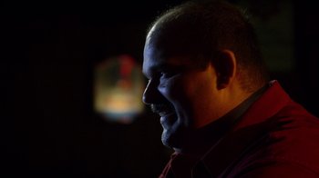 Movie still from “Better Call Saul” (2015), created by Vince Gilligan – A man's face in a dark room; Close Up shot, Low angle