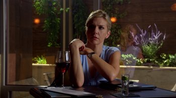 Movie still from “Better Call Saul” (2015), created by Vince Gilligan – A woman sitting at a table in front of a glass of wine; Close Up shot, Over the shoulder angle