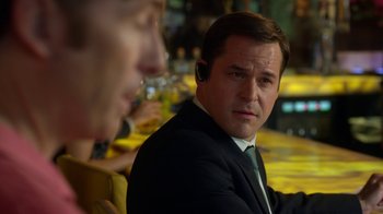 Movie still from “Better Call Saul” (2015), created by Vince Gilligan – A man in a suit and tie sitting next to another man; Close Up shot, Over the shoulder angle
