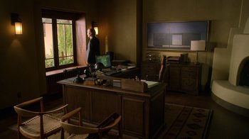 Movie still from “Better Call Saul” (2015), created by Vince Gilligan – A man standing at a computer desk in front of a window; Wide shot, Low angle