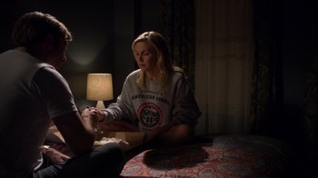 Movie still from “Better Call Saul” (2015), created by Vince Gilligan – A woman sitting on a bed with a lamp; Medium shot, Over the shoulder angle