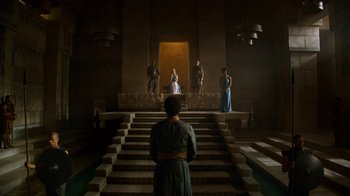 Movie still from “Game of Thrones” (2011), created by D.B. Weiss – A group of people standing on some steps in front of a building; Wide shot, Low angle