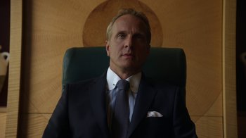 Movie still from “Better Call Saul” (2015), created by Vince Gilligan – A man wearing a suit and tie sitting in a chair; Close Up shot, Low angle