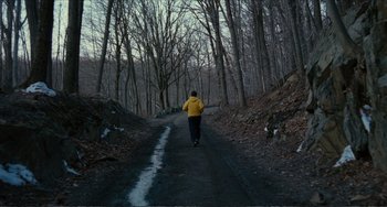 Movie still from “Win Win” (2011), directed by Tom McCarthy – A man in a yellow jacket walking down a dirt road; Extreme Wide shot, High angle