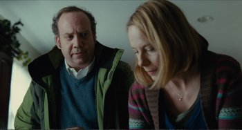 Movie still from “Win Win” (2011), directed by Tom McCarthy – A man and a woman sitting next to each other in a room; Medium shot, Over the shoulder angle