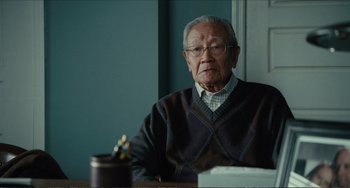Movie still from “Win Win” (2011), directed by Tom McCarthy – An older man sitting at a table with a cup of coffee in front of him; Close Up shot, Low angle