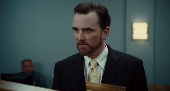 Movie still from “Win Win” (2011), directed by Tom McCarthy – A person wearing a suit and tie; Close Up shot, Over the shoulder angle