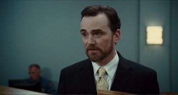 Movie still from “Win Win” (2011), directed by Tom McCarthy – A person wearing a suit and tie; Close Up shot, Over the shoulder angle