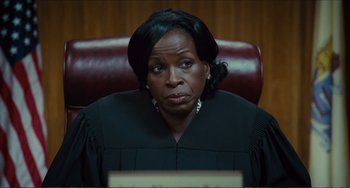 Movie still from “Win Win” (2011), directed by Tom McCarthy – A woman in a black gown sitting in a chair; Close Up shot, Over the shoulder angle