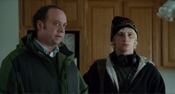 Movie still from “Win Win” (2011), directed by Tom McCarthy – A man standing next to another man in a room; Medium shot, Over the shoulder angle