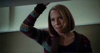 Movie still from “Win Win” (2011), directed by Tom McCarthy – A woman in a colorful sweater smiling for the camera; Close Up shot, Low angle