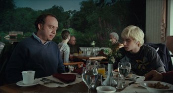 Movie still from “Win Win” (2011), directed by Tom McCarthy – A group of people sitting at a dinner table; Medium shot, Over the shoulder angle