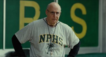 Movie still from “Win Win” (2011), directed by Tom McCarthy – An older man with a bald head wearing a necklace; Medium shot, Over the shoulder angle
