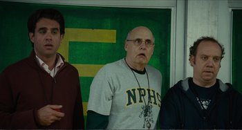 Movie still from “Win Win” (2011), directed by Tom McCarthy – An older man wearing a gray shirt with a cross on it; Medium shot, Low angle