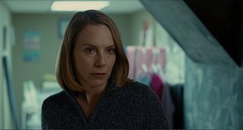Movie still from “Win Win” (2011), directed by Tom McCarthy – A woman in a sweater is looking at the camera; Close Up shot, Over the shoulder angle