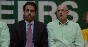 Movie still from “Win Win” (2011), directed by Tom McCarthy – Two men sitting next to each other wearing suits; Medium shot, Over the shoulder angle