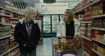 Movie still from “Win Win” (2011), directed by Tom McCarthy – Two people standing in a grocery store with a shopping cart; Medium shot, Over the shoulder angle