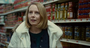 Movie still from “Win Win” (2011), directed by Tom McCarthy – A woman standing in front of shelves in a grocery store; Close Up shot, Over the shoulder angle