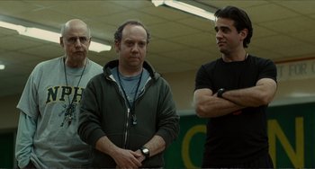 Movie still from “Win Win” (2011), directed by Tom McCarthy – A group of men standing next to each other in a room; Medium shot, Low angle