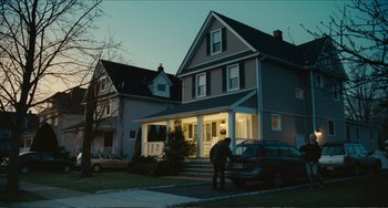Movie still from “Win Win” (2011), directed by Tom McCarthy – A person standing in front of a house at night; Extreme Wide shot, Over the shoulder angle