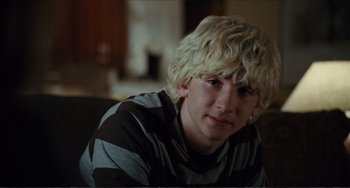 Movie still from “Win Win” (2011), directed by Tom McCarthy – A young man with blonde hair sitting in a room; Close Up shot, Over the shoulder angle